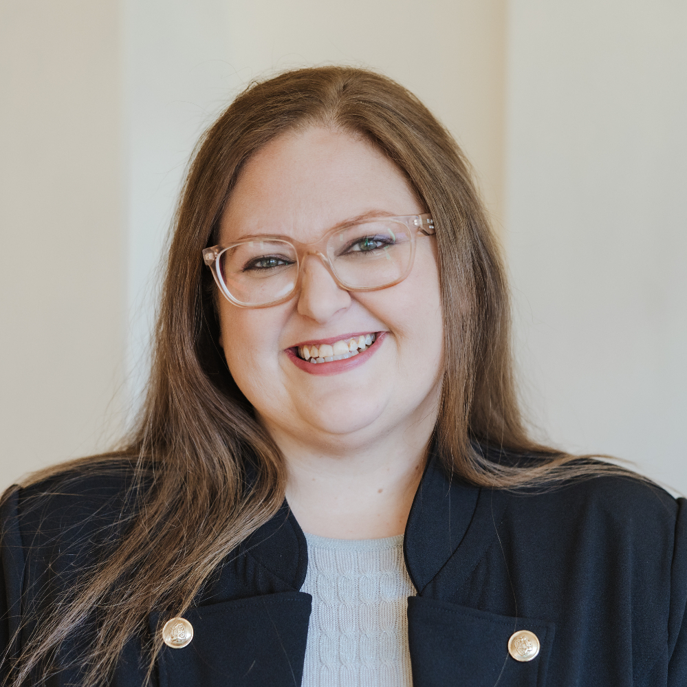 Person wearing glasses and smiling.