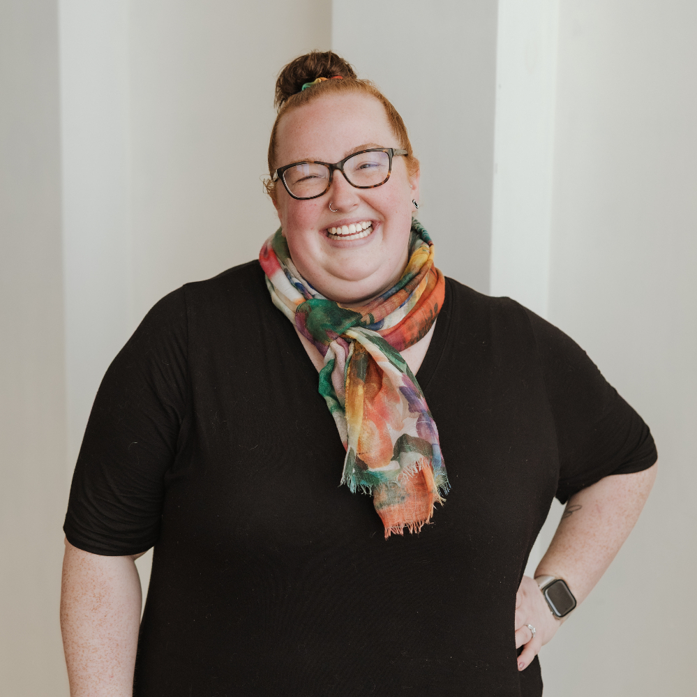 Person wearing glasses and smiling.