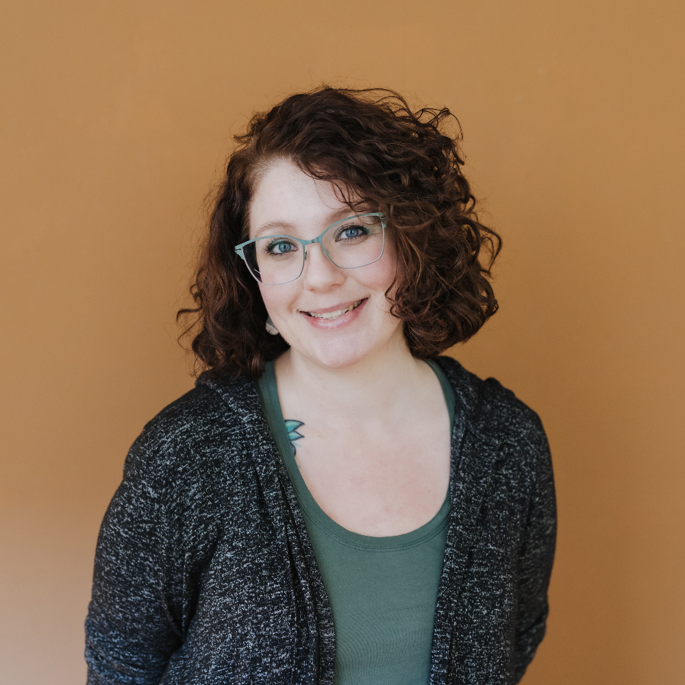 Person wearing glasses and smiling.