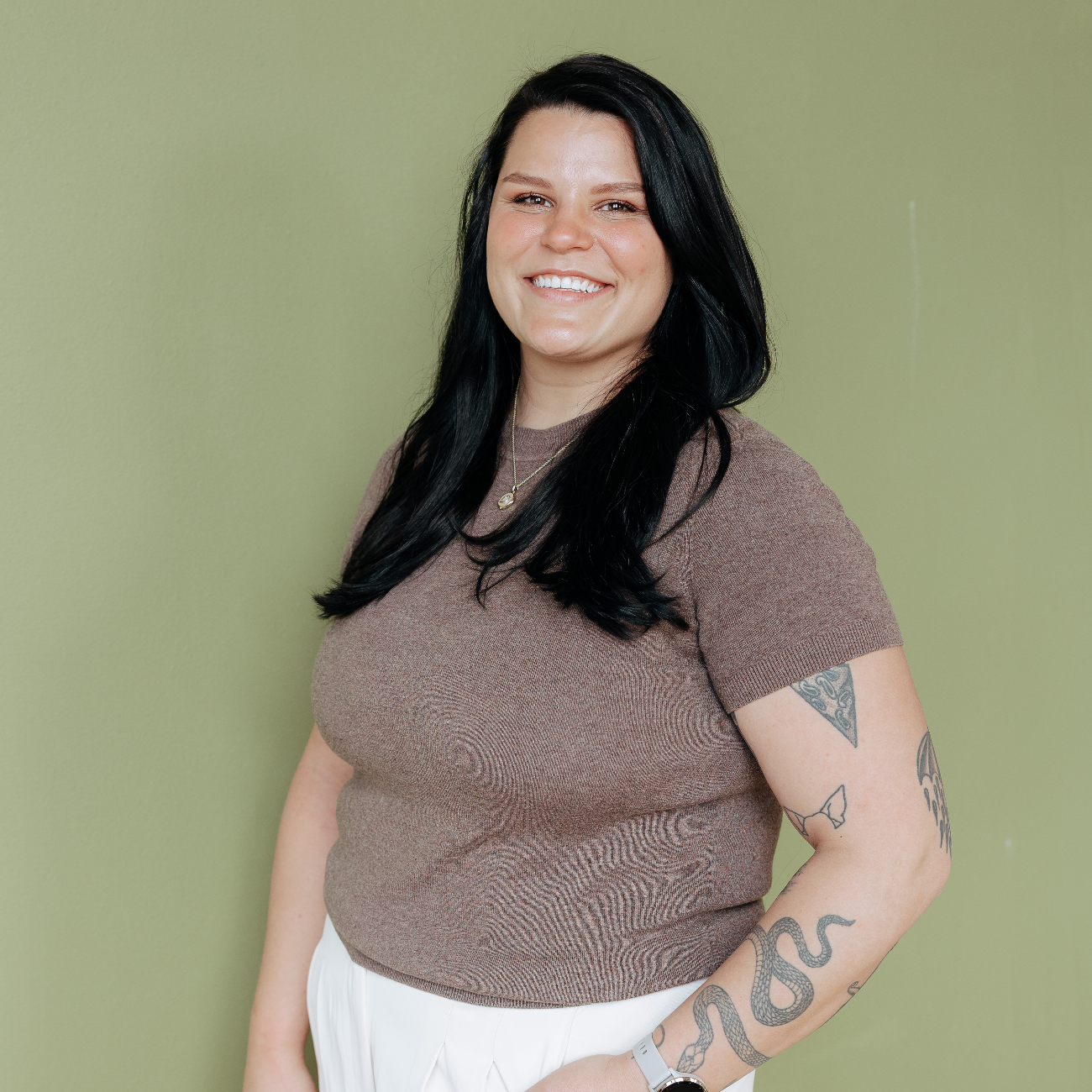 Brunette woman smiling at the camera.
