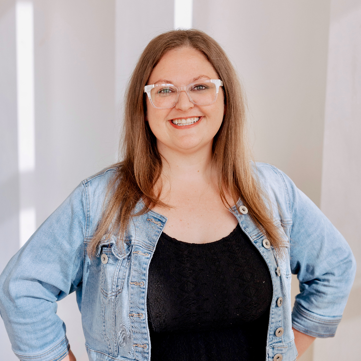 Person wearing glasses and smiling.