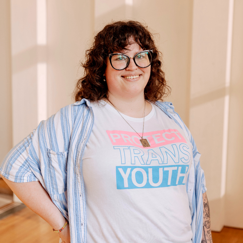 Person wearing glasses and smiling.