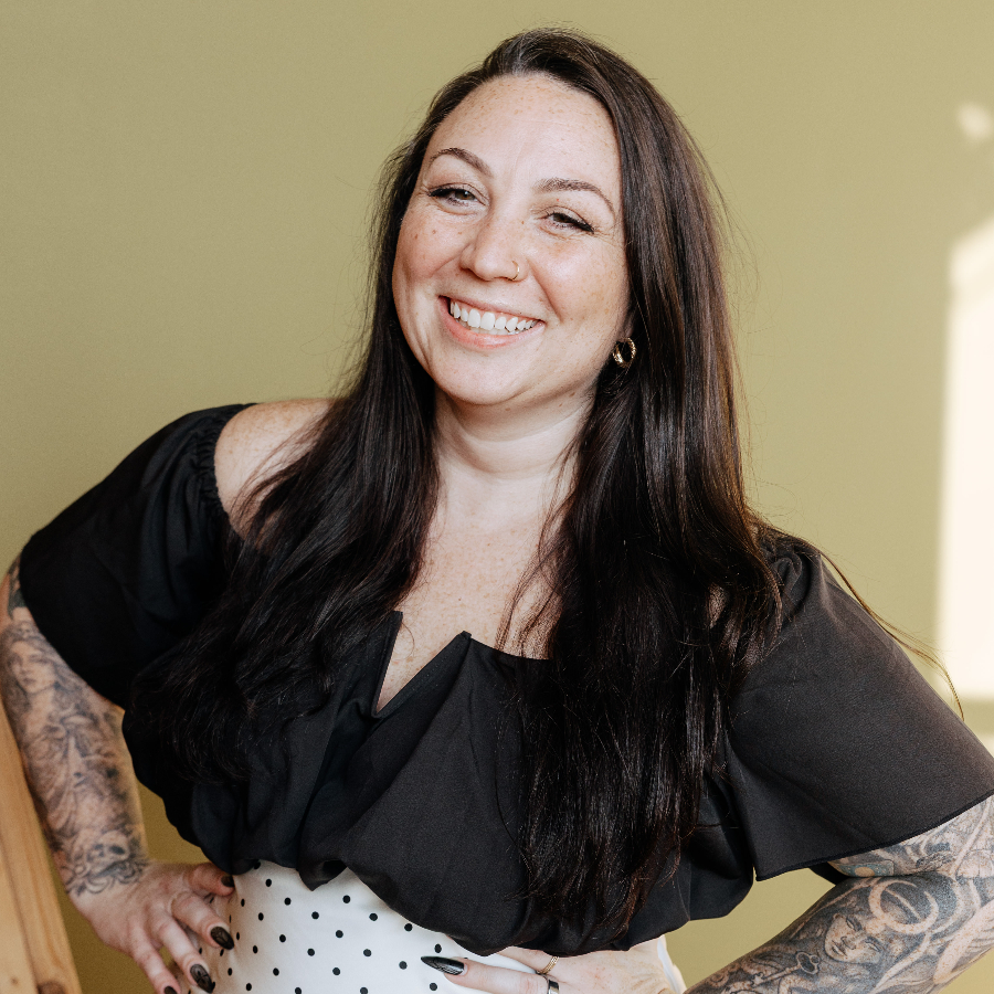 Person in a black top smiling.